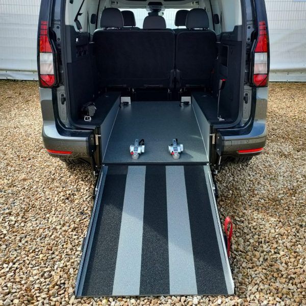 Van ramp. Adapted vehicle for wheelchair. The ramp's floor is vinyl flooring Dragon